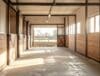 Horse barn with open windows, ridge vents, and bright natural lighting.